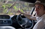 Guide pointing out giraffe through windscreen, Stellenbosch, South Africa