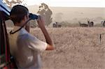 Young man watching wildlife through binoculars, Stellenbosch, South Africa