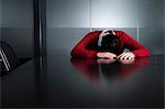 Business executive slumped facedown on meeting table