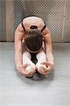 Ballet dancer sitting on floor, stretching