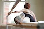 Ballet dancer warming up, foot on bar