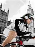 Cyclist with Houses of Parliament in background, London, England