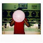 Instant film photograph of man with balloon saying 'I love you'