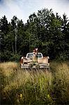 Fisherman with rod on back of pickup truck, Cape Breton Island, Nova Scotia