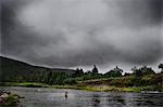 Fly fisherman in Margaree River, Cape Breton Island, Nova Scotia