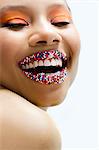 Portrait of young woman with lips covered with sprinkles