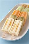 Homemade fruit ice lollies on tray