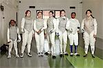 Portrait of female fencers standing together in a row
