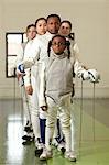 Female fencers standing in line