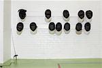 Fencing masks hanging from wall