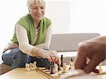 Senior couple playing chess at home