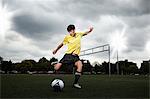 Soccer player about to kick ball on pitch