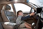 Little boy pretending to drive car