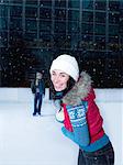 Woman skating on an ice rink in the snow