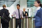 Mid adult businessmen entering building through security gate