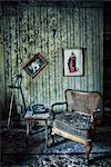 Abandoned room with chair and pictures