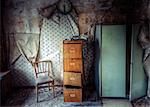 Abandoned building with chair and filing cabinet