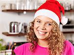 Portrait of young woman wearing Santa hat, smiling