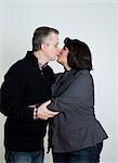 Mature couple kissing, studio shot