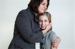 Mature woman hugging daughter, portrait