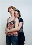 Portrait of lesbian couple embracing, studio shot