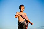 Boy playing with striped fabric