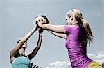 Two women holding ball