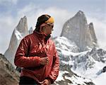 Woman zips her jacket in front of Monte Fitz Roy in Los Glaciares National Park, El Chalten, Argentina