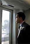 Businessman on a train, looking through window