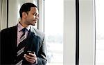 Businessman looking through window on a train