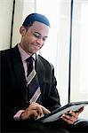 Businessman using digital tablet on a train