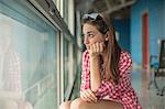 Teenage girl looking through window