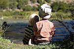 Brothers sitting by the lake