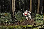 Mountain biker on muddy forest track