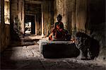 Buddha statue at the Ta Prohm Temple ruins at  Angkor Wat, Siem Reap, Cambodia