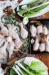 Preparing chicken legs and spring vegetables