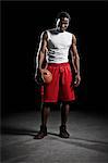 Studio shot of basketball player holding ball