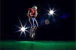 American football player mid air with ball