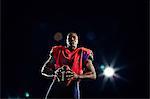 Portrait of american football player with ball