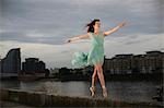 Ballet dancer standing on tiptoe on wall