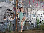 Ballet dancer by wall with graffiti