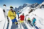 Group of skiers climbing up mountain