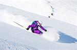 Female skiing downhill at speed