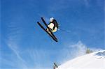 Male skier jumping mid air on mountain