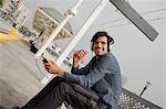 Man wearing headphones at station, Los Angeles, California, USA