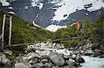 Man crossing bridge over Rio del Frances,Torres del Paine National Park, Chile