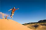 Male hiker running on Star Dune, Coral Pink Sand Dunes State Park, Utah, USA