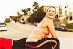 Two runners taking a break on a city hill