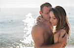 Romantic young couple embracing on beach, Castiadas, Sardinia, Italy