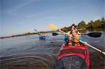 Family canoeing on lake, Staffelsee, Murnau, Oberbayern, Bavaria, Germany